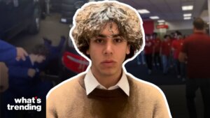 Young man with curly hair wearing a brown sweater and white collared shirt, "what's trending" logo in corner