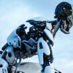 Futuristic white and black humanoid robot kneeling on rocky terrain near water under a blue sky